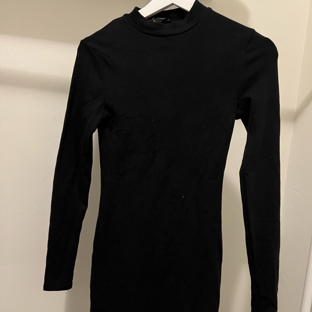 Black dress with mock neck and U shape hem line